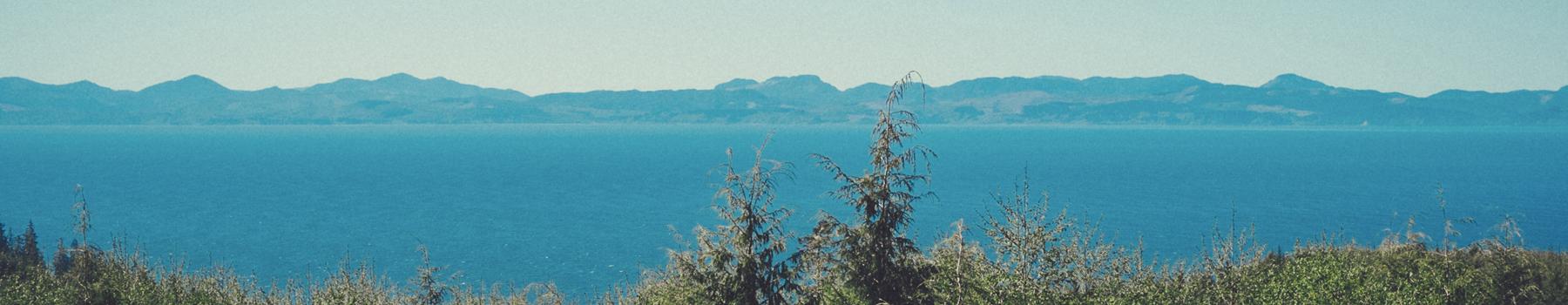 Photo of a blue lake with mountains in the distance